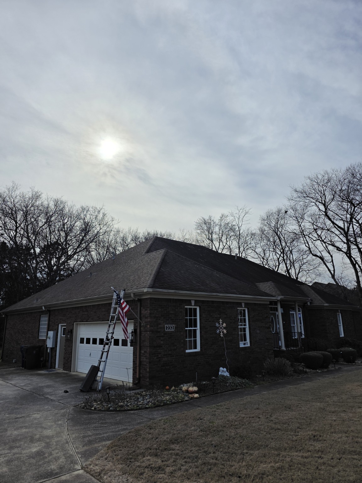 Front of a large Huntsville home before roof replacement