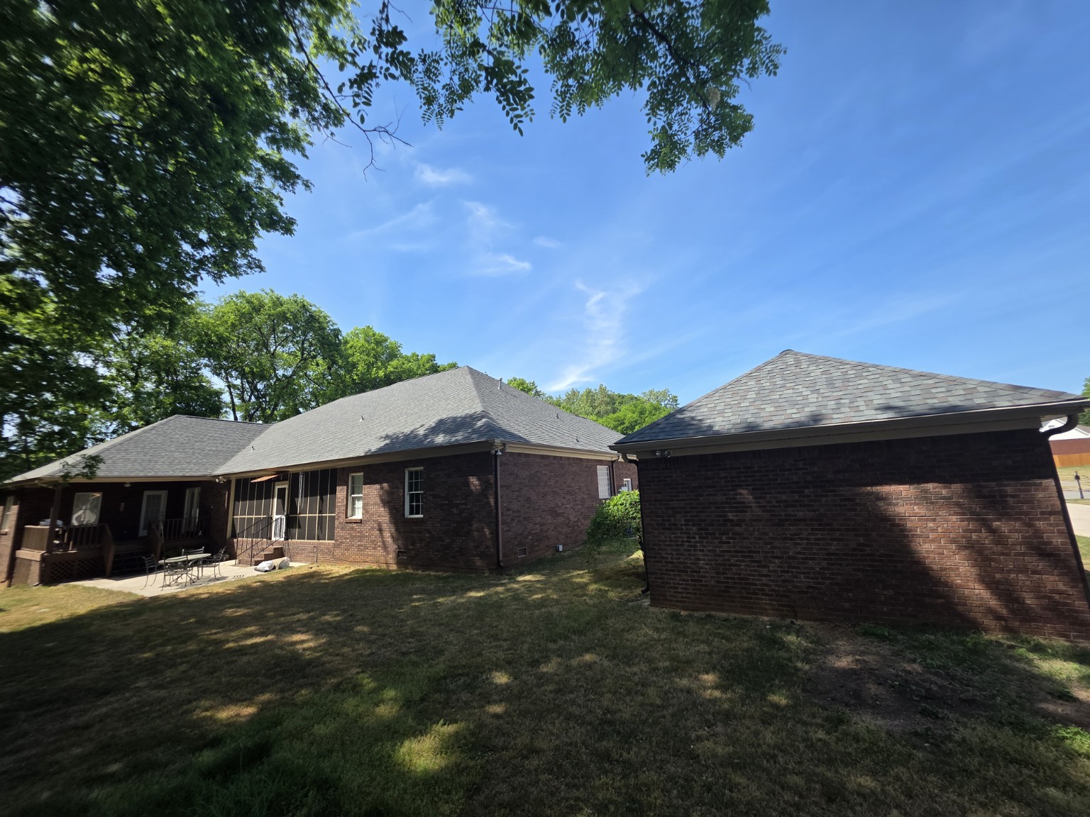 Rear elevations and detached garage after roof replacement