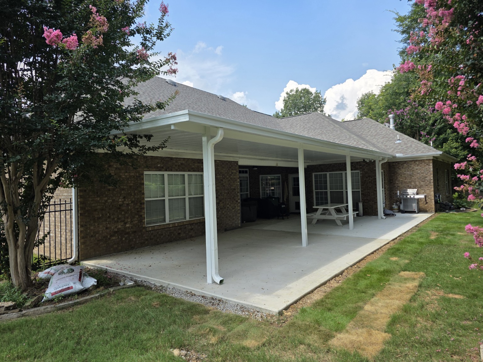 Completed full-width white covered porch by Laney Construction