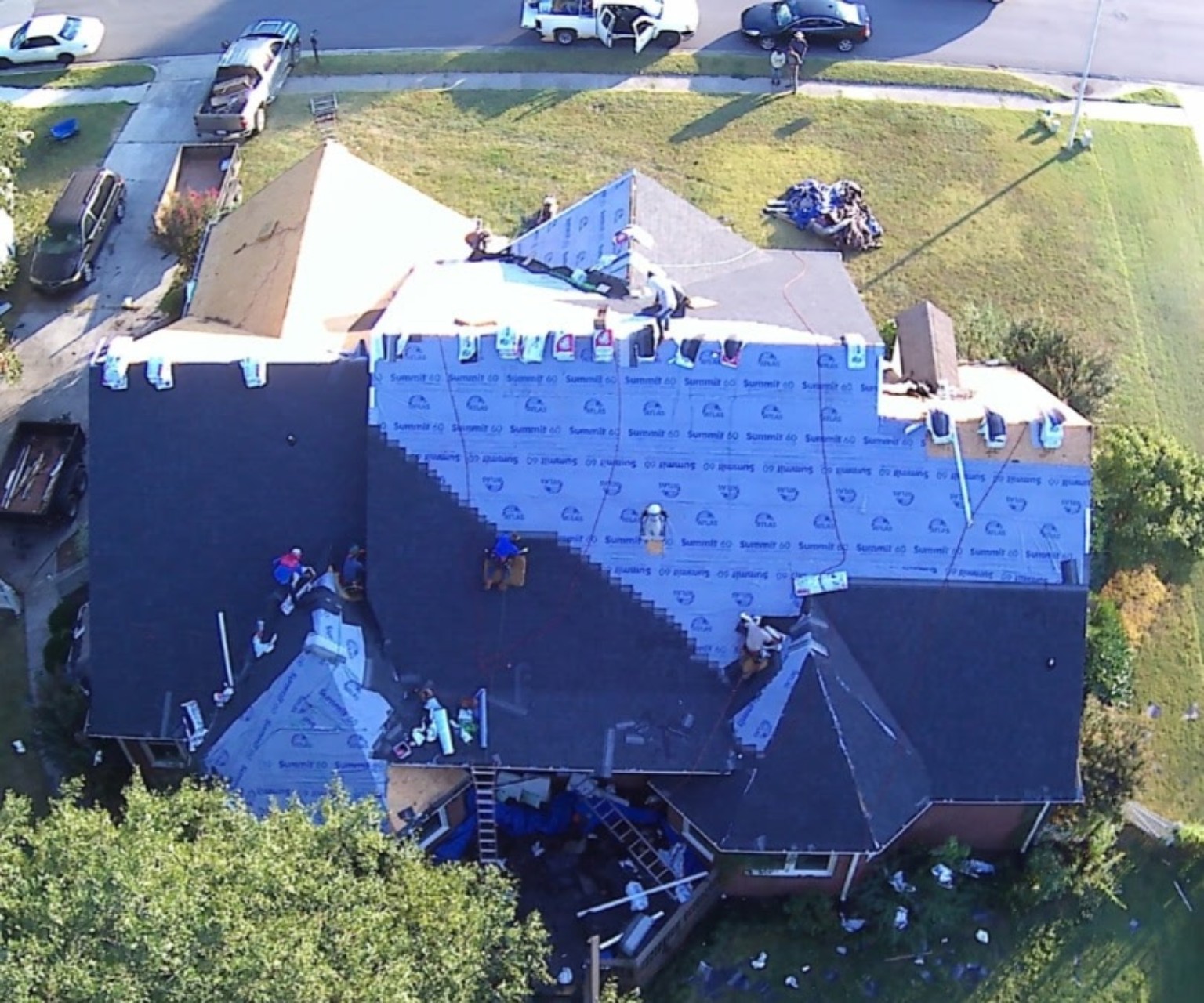 Laney roofing crew installing a complete roofing system with synthetic underlayment